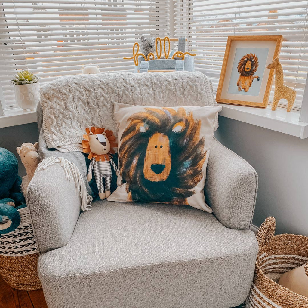 A nursing chair with a lion children's cushion