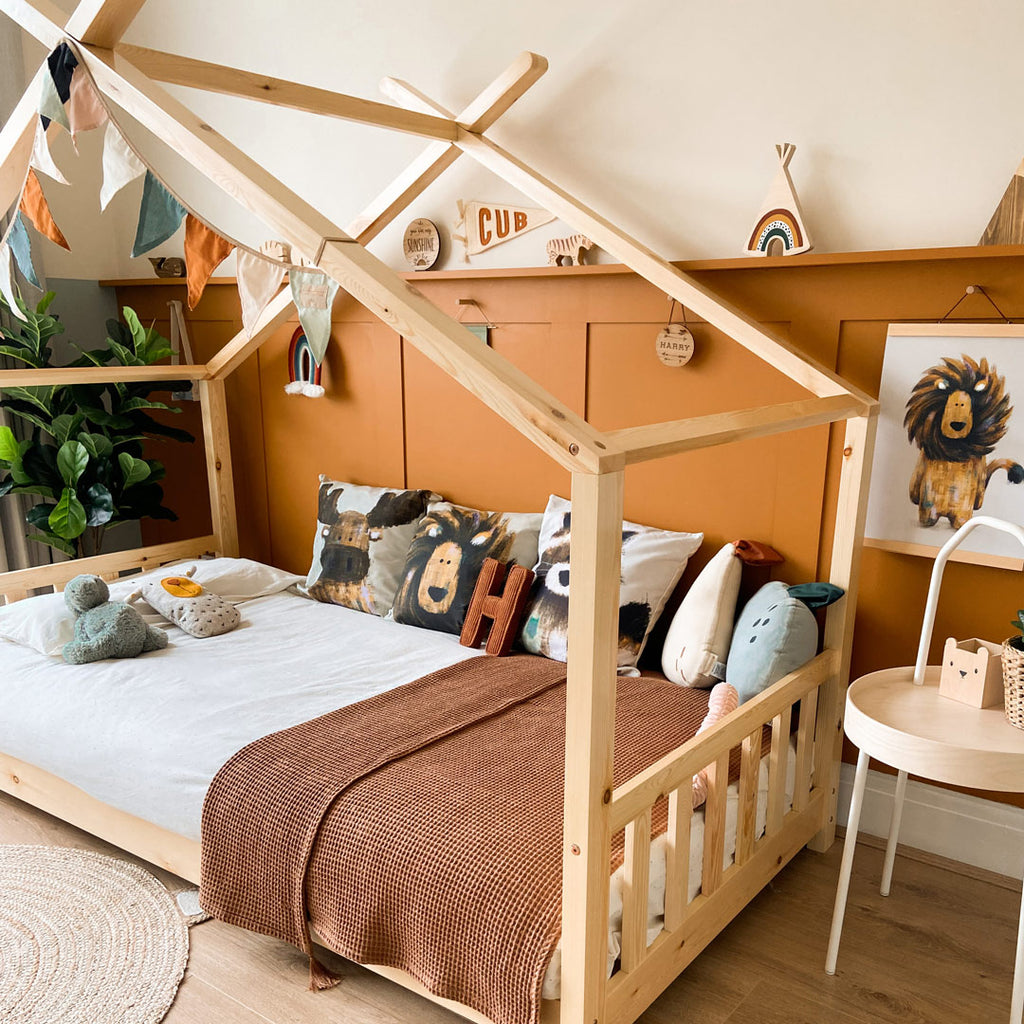 Kid's bed covered with safari theme children's cushions