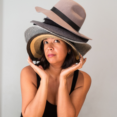 woman wearing multiple hats