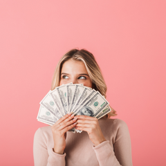 Woman holding money up