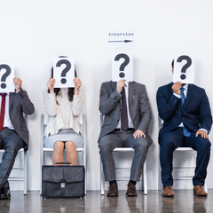 Office workers holding quesiton marks over face