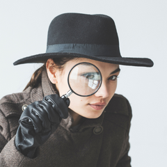 Woman looking through magnifying glass