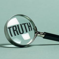 Magnifying glass on the word "truth"