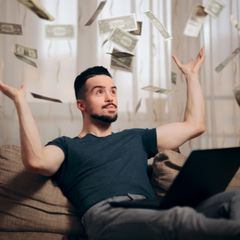 man throwing money on couch