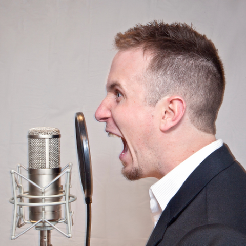 Man screaming into microphone