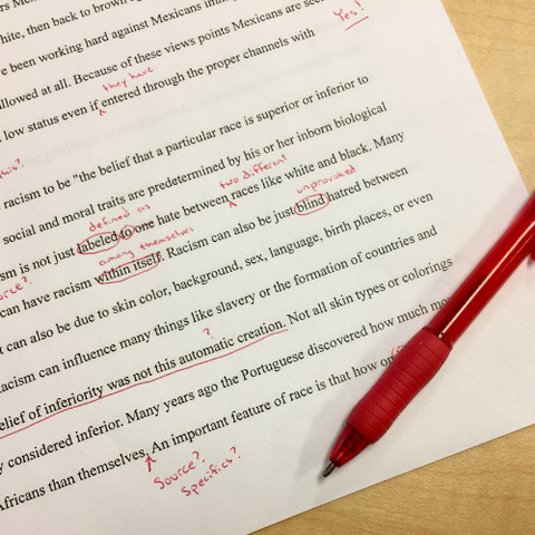 editing writing with red pen