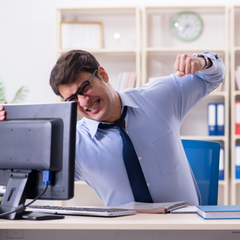 Angry office worker punching desktop