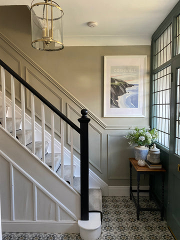 Traditional panelling up stairs painted in warm green/ grey