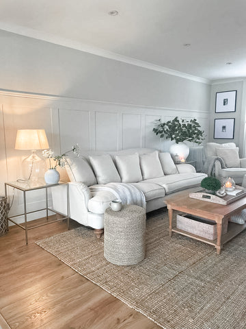 Shaker panelled living room wall, painted white with sofa and coffee table in front