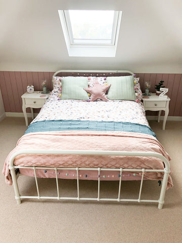 Pink shiplap panelling in bedroom 