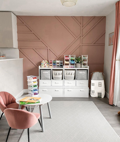 Pink geometric wall panelling in a playroom