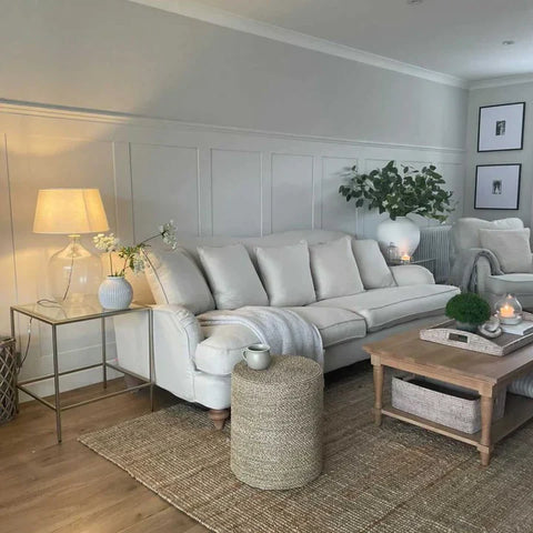 White shaker panelling on wall behind a white sofa