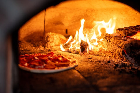 Pizza baked inside a fire oven - The Woodfired Co
