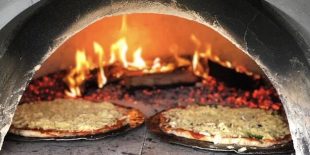 Pizzas cooking in a wood fired oven