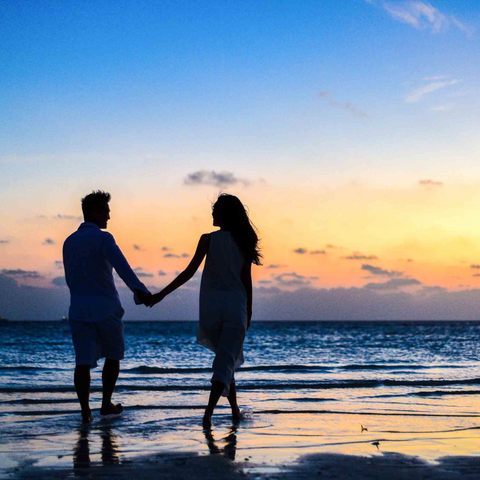 couple holding hands on Maui beach