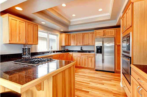 A large kitchen with solid wood cabinets and hardwood flooring. 