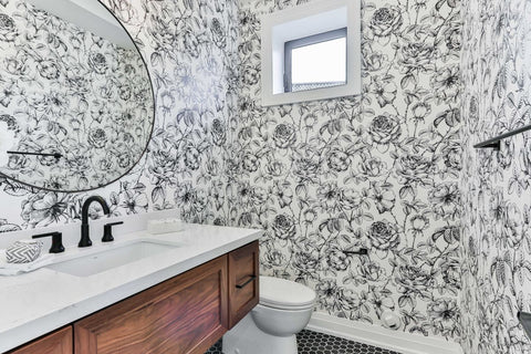 A bathroom with black and white wallpaper