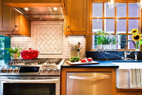 A kitchen with solid wood oak cabinets and a stainless steel stove. 