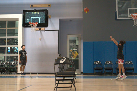 Trainer rebounding for young player.