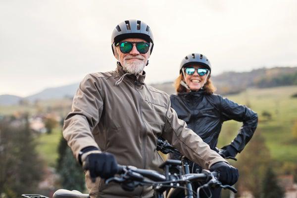 Couple Riding E-Bikes through the Park