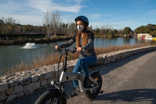 Girl Riding Electric Folding Bike Through Park