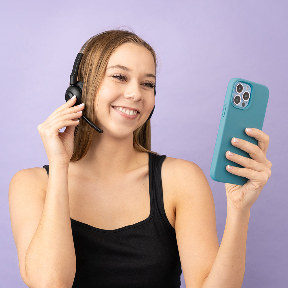 Woman wearing GO Work POP On-Ear Headset and touching boom microphone