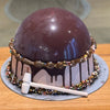 A round chocolate dome smash cake covered in ganache, filled with Ben & Jerry’s ice cream and assorted sweets, perfect for birthdays in Melbourne.