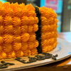 Round orange and black basketball cake made with ice cream for Melbourne celebrations.