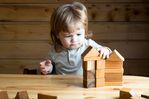 Child playing with wooden blocks