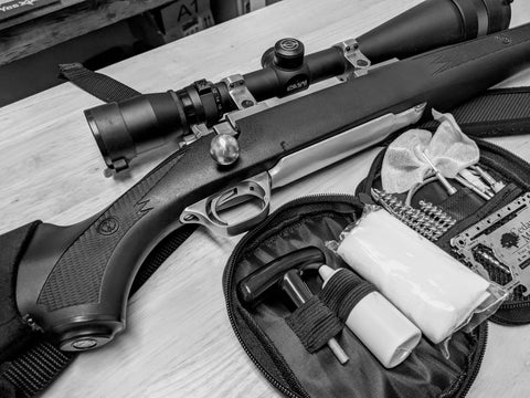 A rifle with a cleaning kit