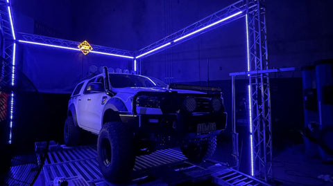 290 box truss frame around a car. The truss frame is lit up with LED strip lighting 