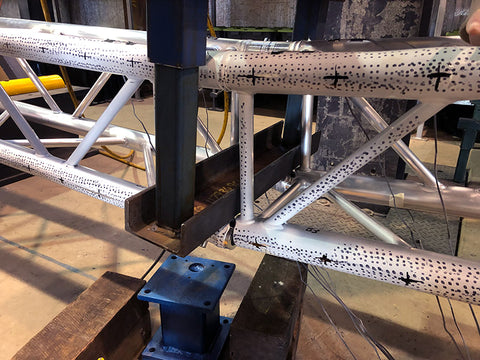 two connected pieces of truss with a crack from applying tonnes of force in a safety test