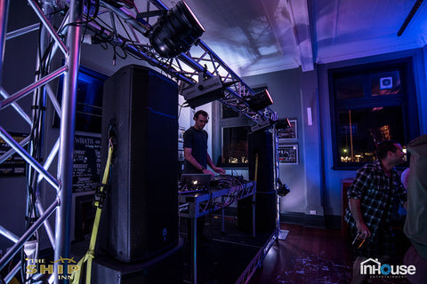 290 Tri Truss frame above a DJ setup inside a club.