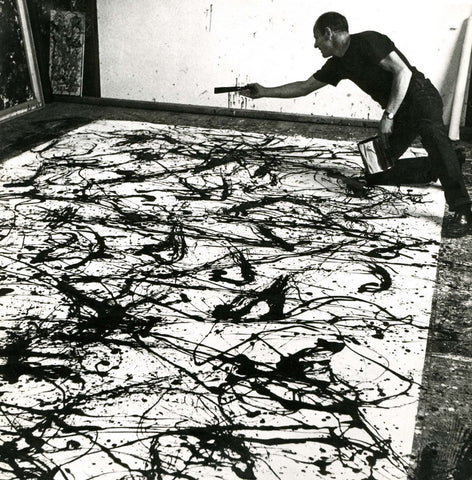 Jackson Pollock in his studio painting