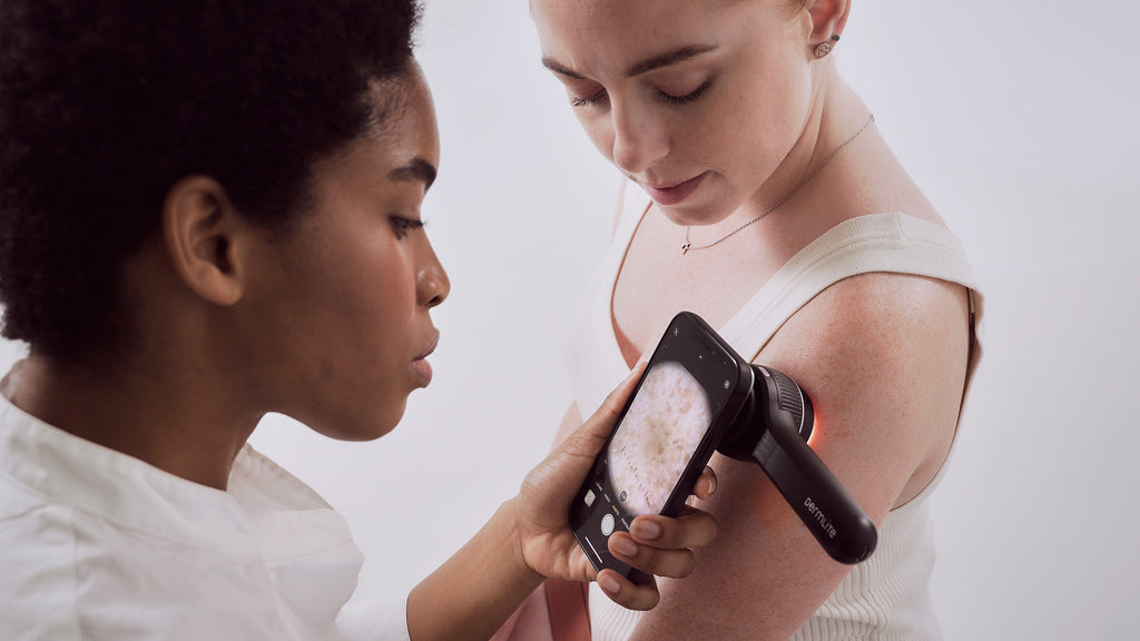 Health care professional using a dermlite DL4 dermatoscope on patient