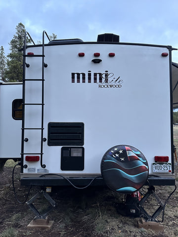 A camper showing the American flag spare tire cover