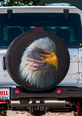 bald eagle spare tire cover for Jeep, Bronco, or other with the American flag superimposed to look like a tattoo across the eagles eye