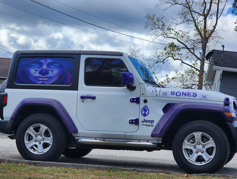 White Jeep Wrangler with light purple color accents and a sugar skull window decal design