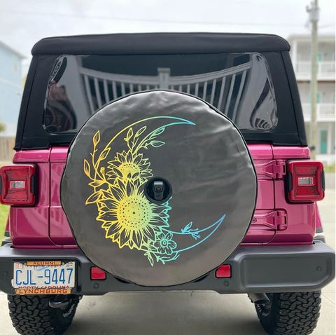 Tuscadero Pink Jeep Wrangler with a multicolor spare tire cover of a moon and flowers that coordinates with a Pink Jeep