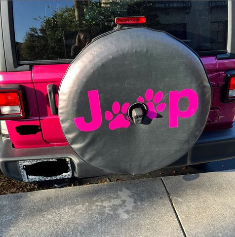 The word Jeep with the two E's as paw prints in Tuscadero pink spare tire cover on a Tuscadero pink Jeep wrangler