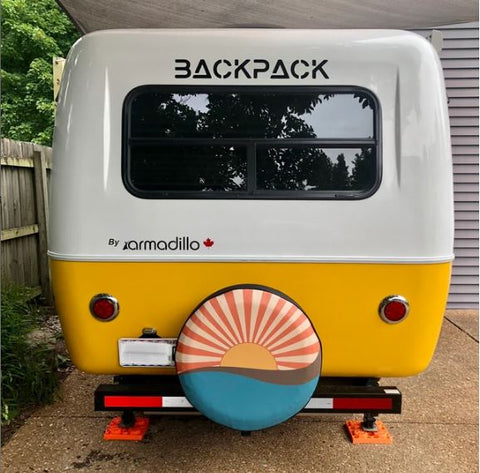 backpack RV in cream and vintage yellow with a matching sun rays and water spare tire cover for RV