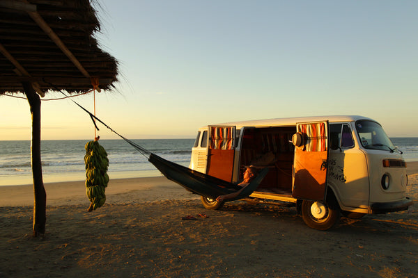 Moskito Traveller Hammock tied to a campervan and wooden post