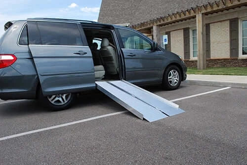 american access sidekick ramp leaning against a mini van