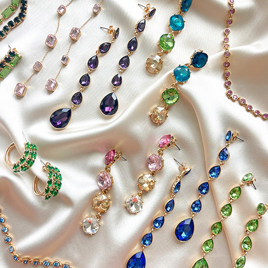 A flat lay of ettika colorful crystal jewelry