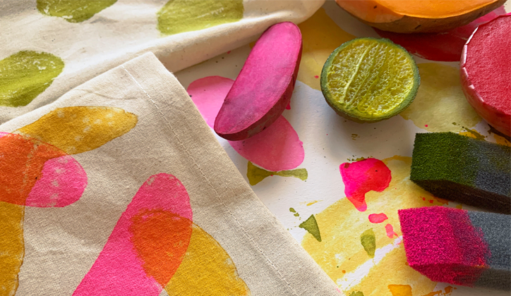 Colorful potato and lime stamps on table with brushes and canvas