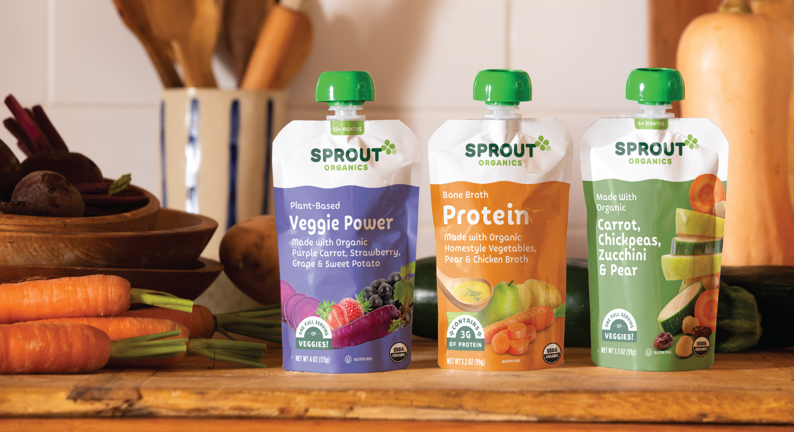 Three Sprout Organics pouches sit on a counter