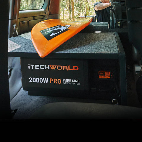 A photo of an iTechWorld 2000W Pro power inverter sitting in a van