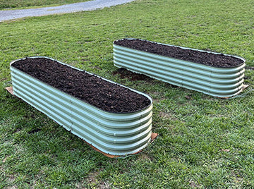 two metal raised garden beds filling with soil-Vegega