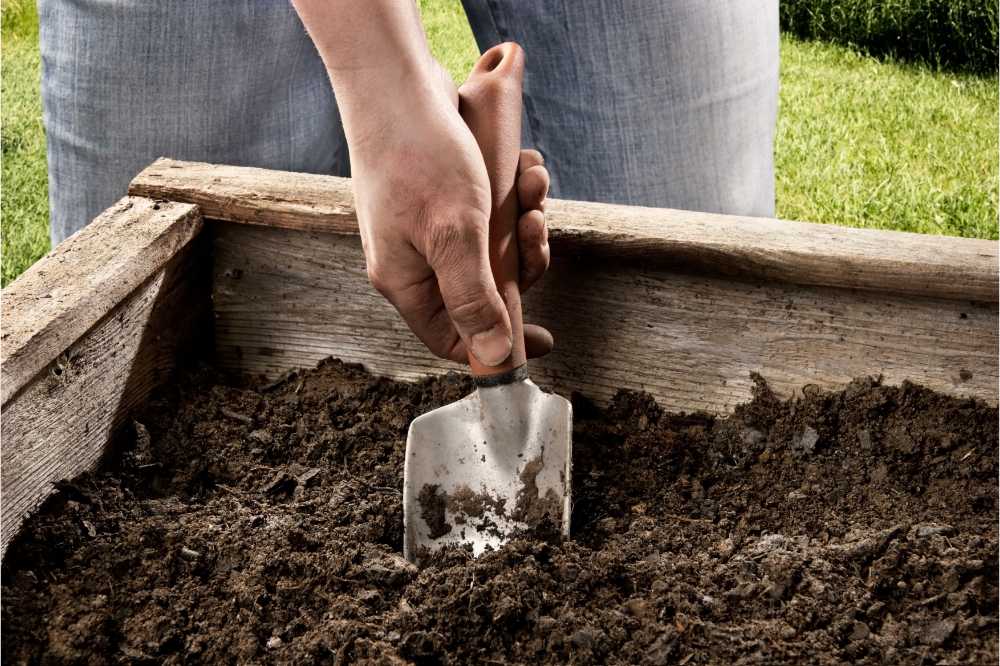 digging in a raised bed for preparation