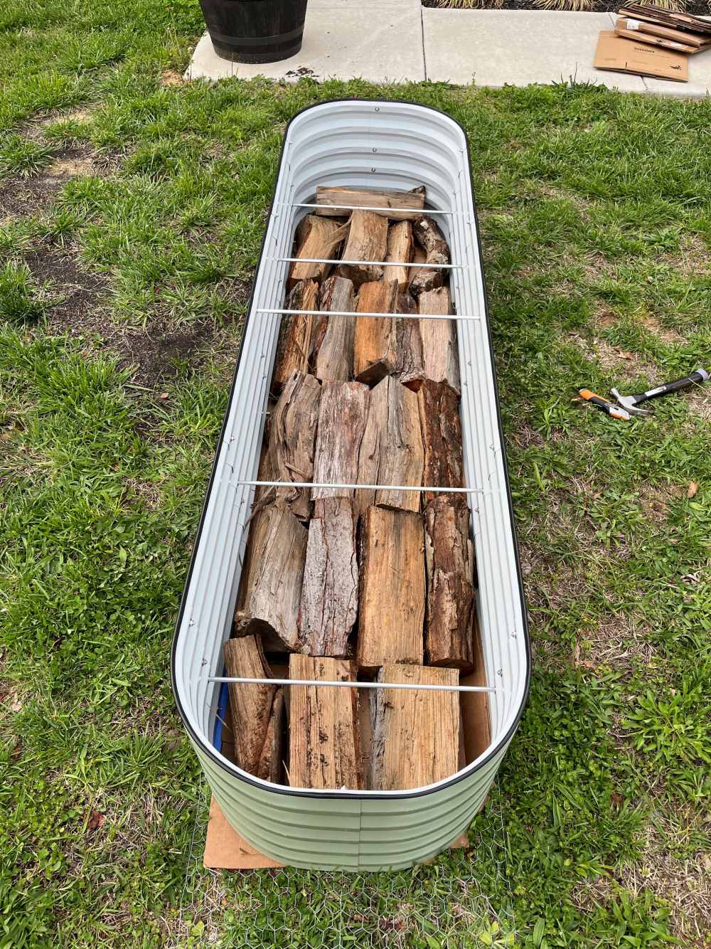 logs filled in hugelkultur raised garden bed-Vegega